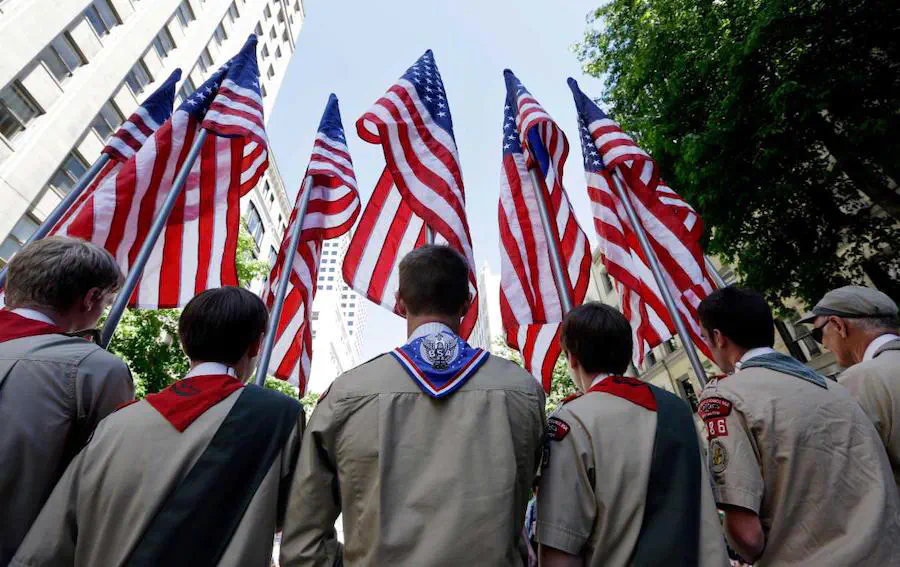 Scouts in front of American flags